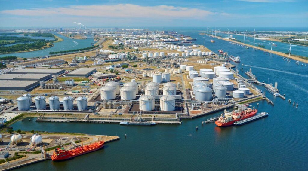 Ammonia carrier ship at a hydrogen terminal with storage tanks and port infrastructure
