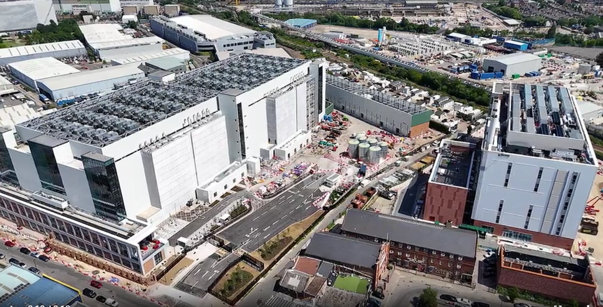 Aerial view of a AI infrastructure campus with multiple buildings and rooftop cooling equipment